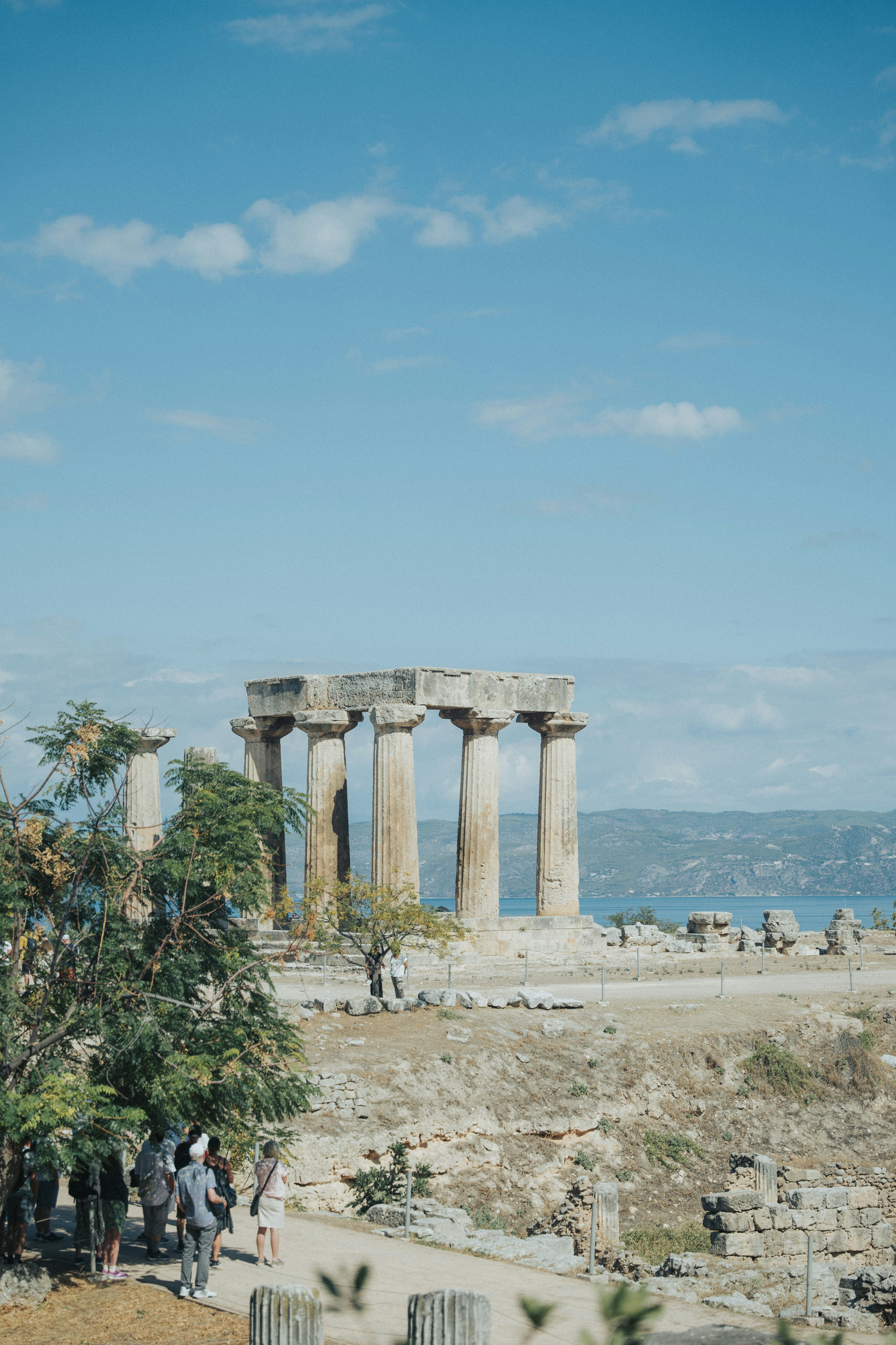 a group of people standing in front of a large stone structure
