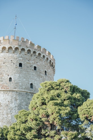 a stone castle with trees in front of it