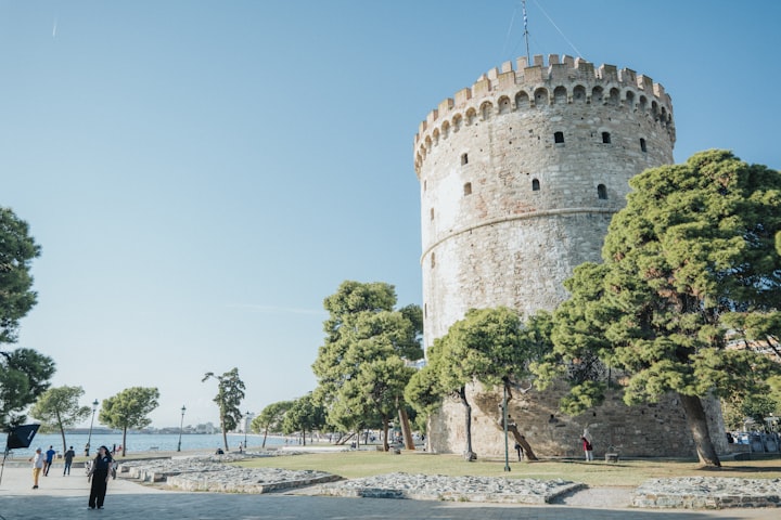 Thessaloniki White Tower on the waterfront at sunset with the Thermaic Gulf behind