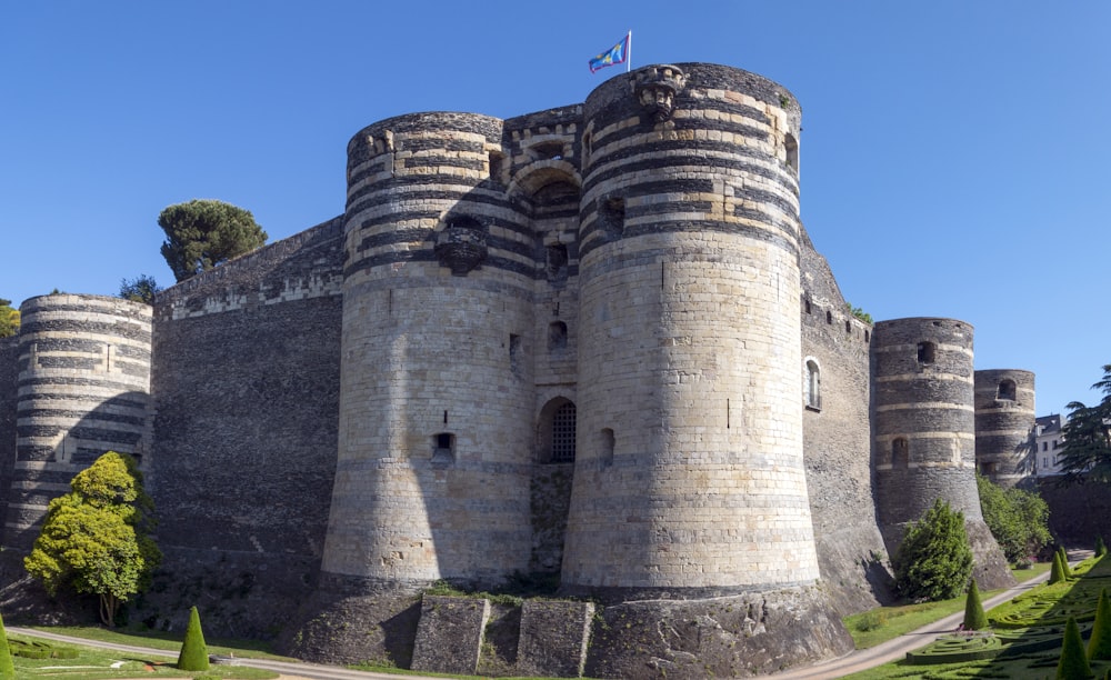 a stone castle with a flag on top