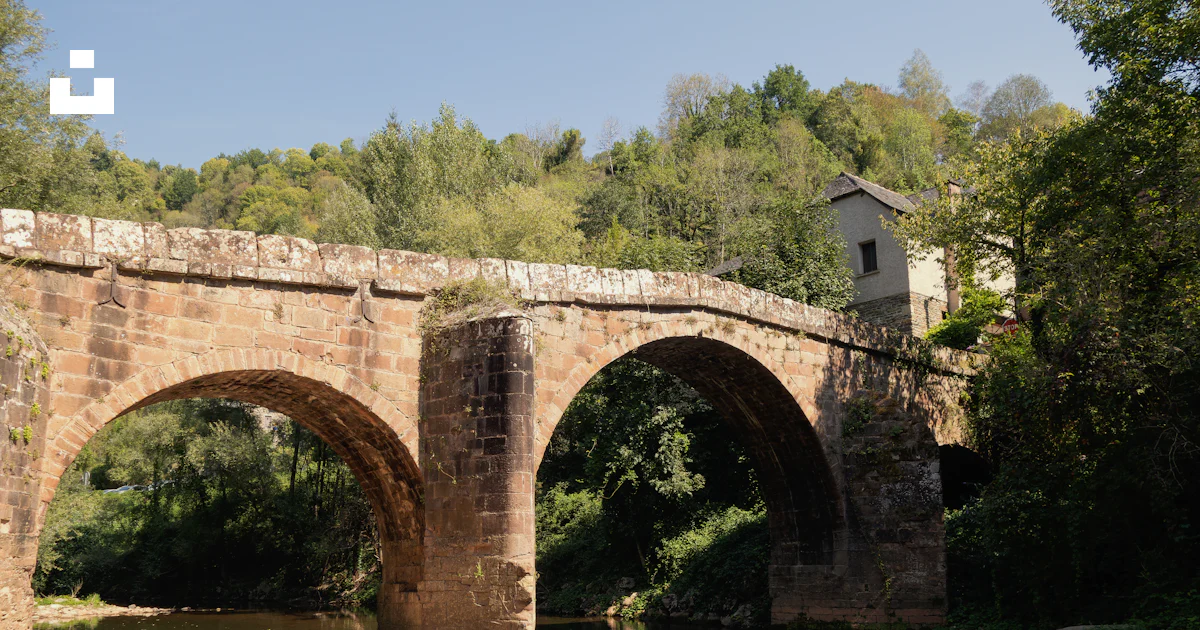A stone bridge over a river photo – Free Conques Image on Unsplash