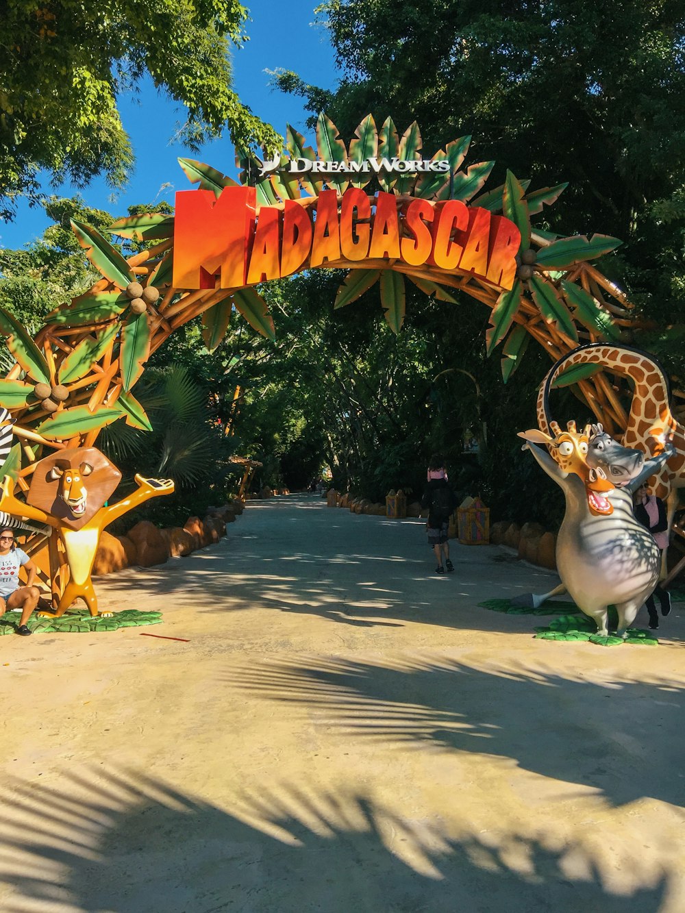 a large colorful sign with a group of people walking around