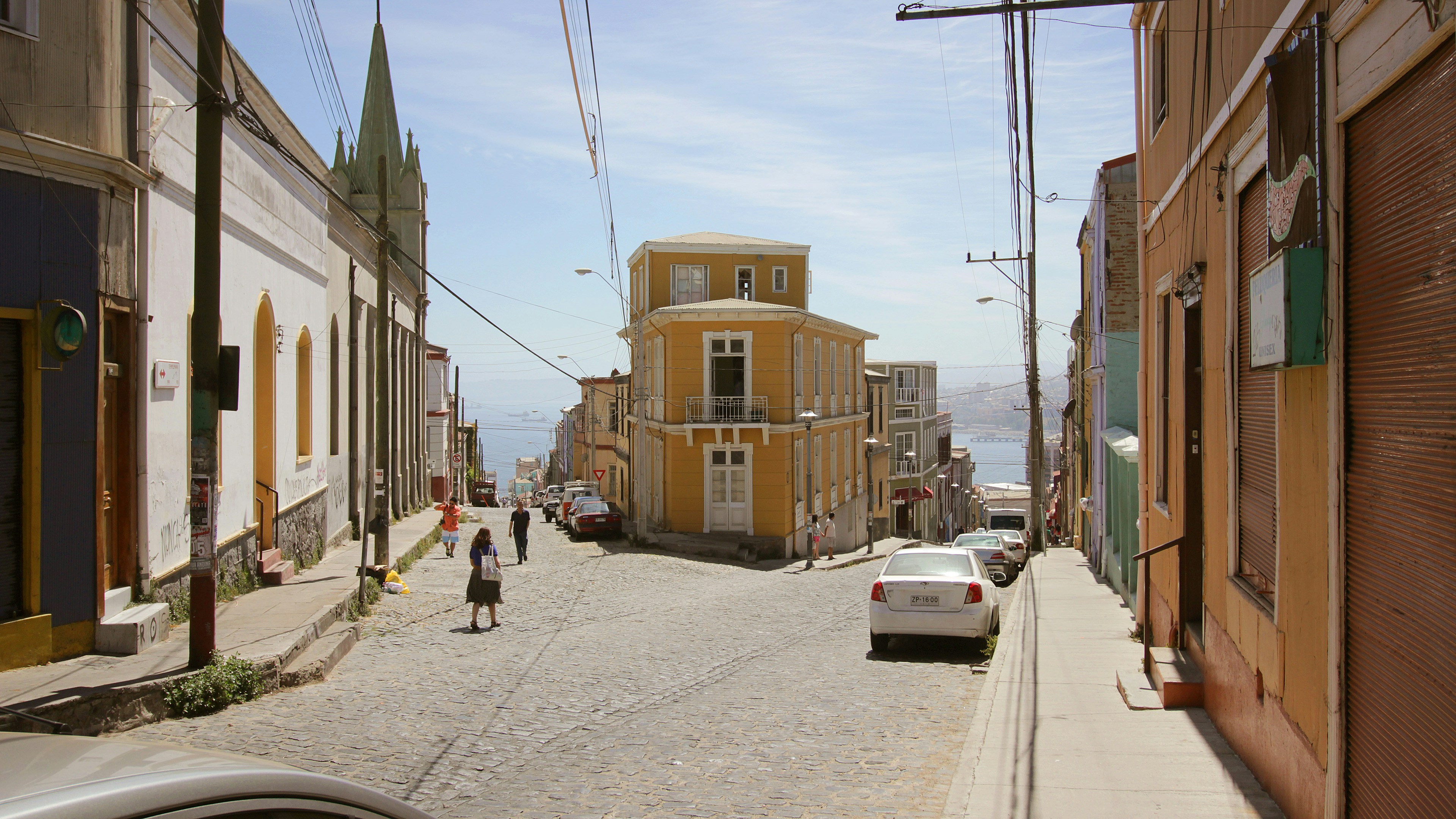 a street with cars and buildings on either side of it, 