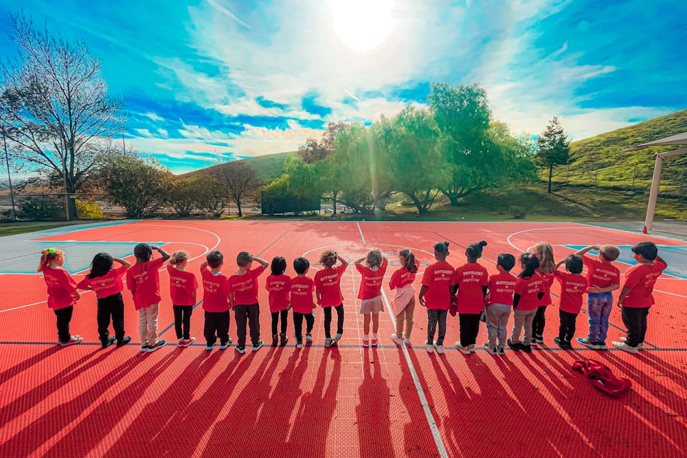 a group of children in red uniforms