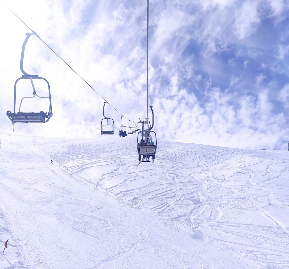 a ski lift going up a snowy mountain