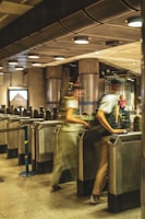 A modern turnstile in a busy urban setting.