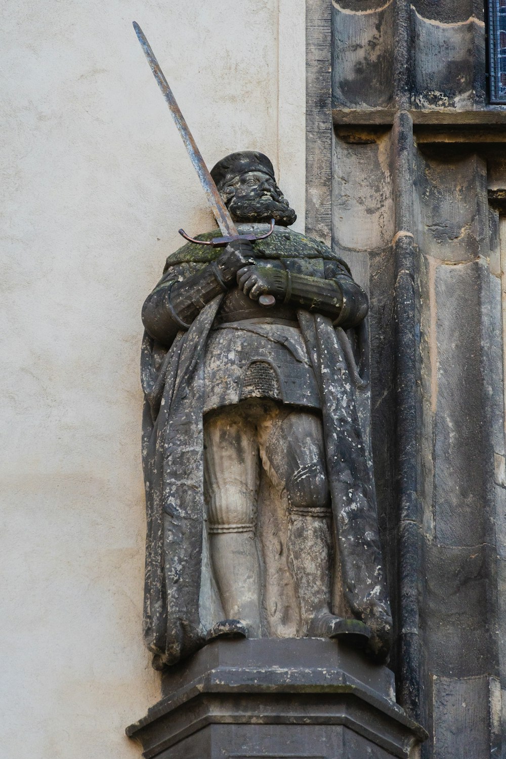 a statue of a person holding a sword