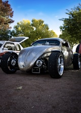 A gleaming custom-painted car parked outside AG Custom Garage under a clear blue sky.