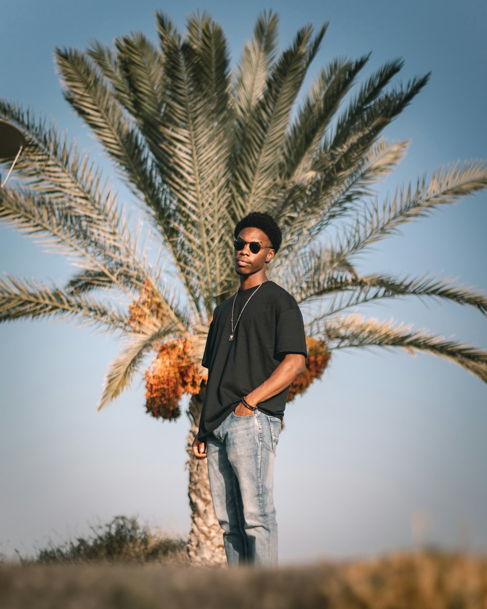 a man standing next to a tree