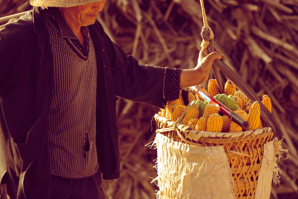 a woman holding a basket of corn