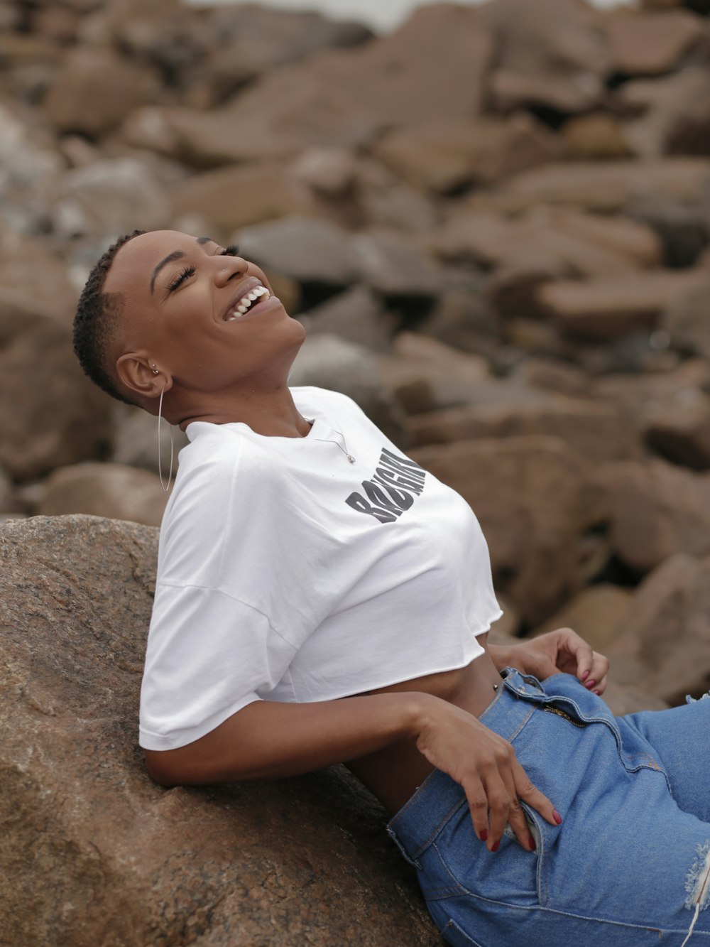 a boy lying on a rock