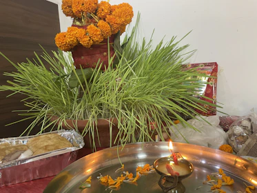 A warm, glowing diya surrounded by marigold flowers, symbolizing light and devotion during festival celebrations.