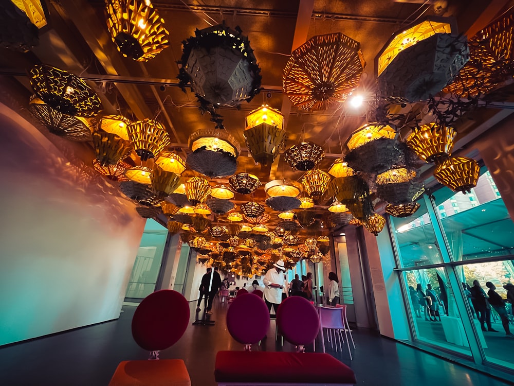 a room with chandeliers and chairs