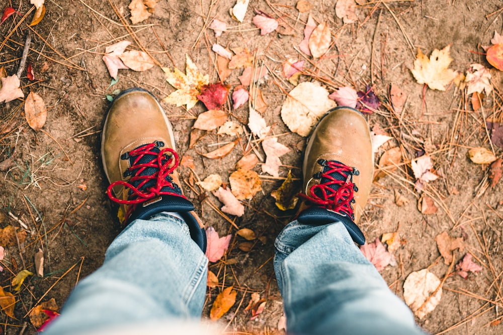 a person's feet in a pile of leaves