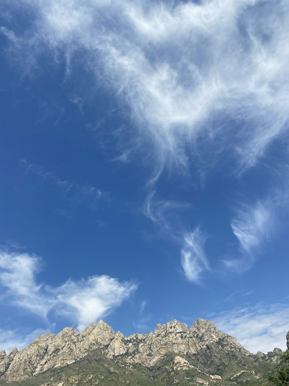 a mountain with clouds above