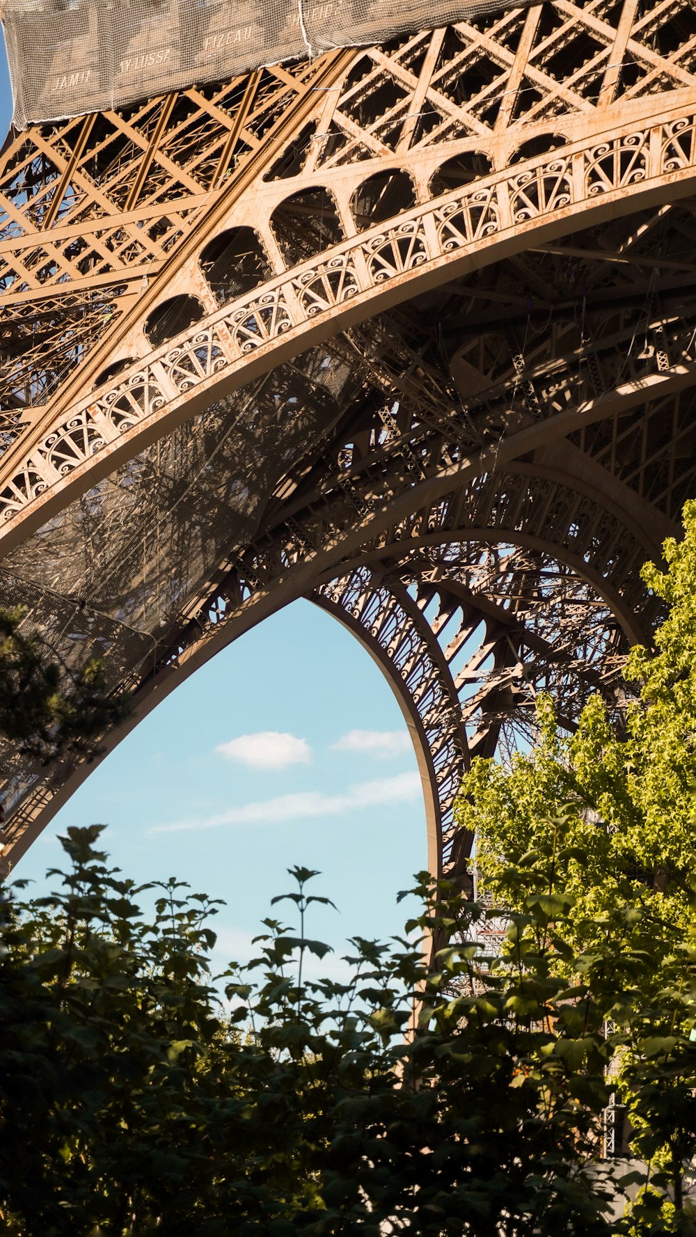 a large metal structure with trees around it