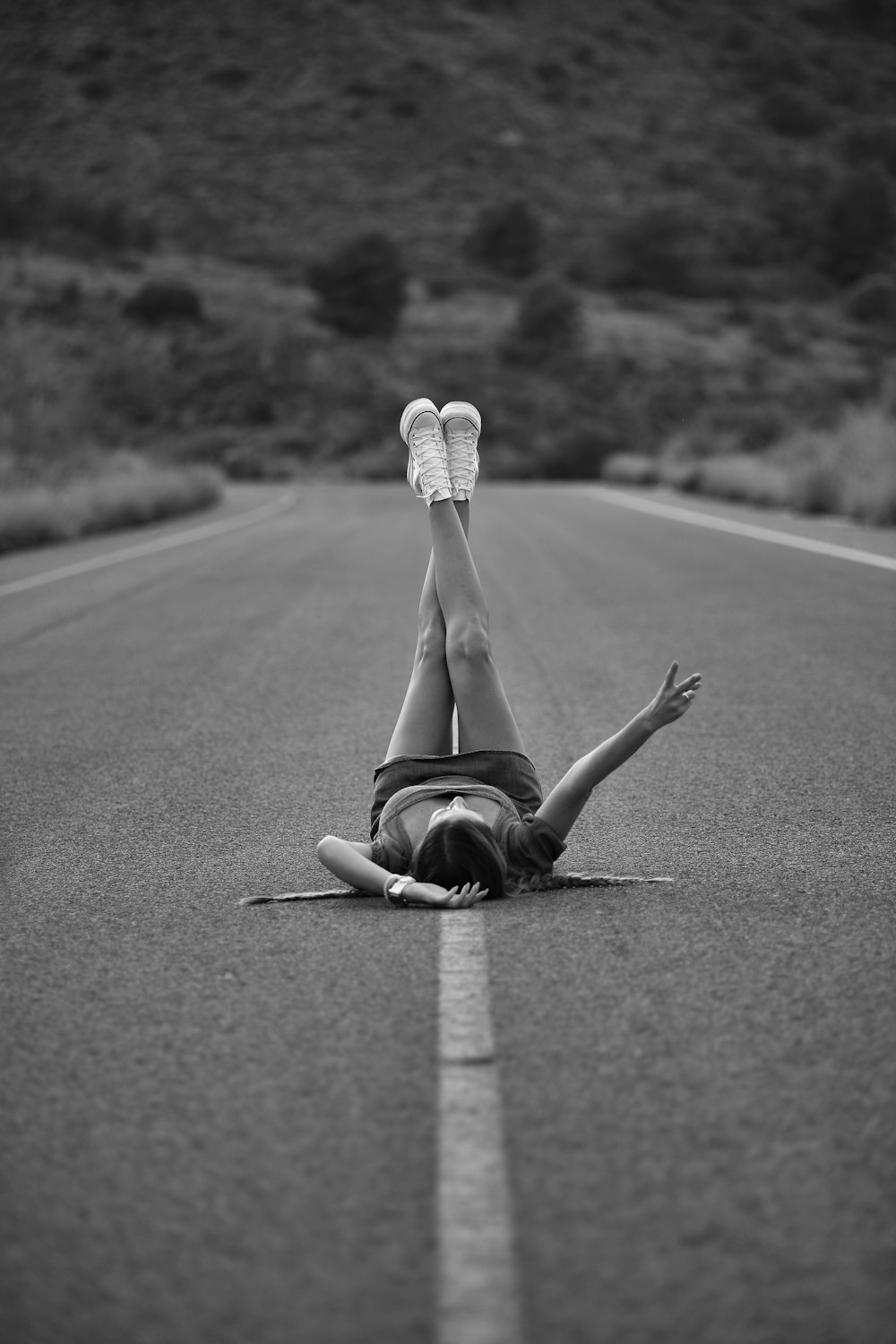a person doing a handstand on a road