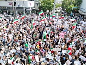 A large crowd of Iranian protesters gathered in a public square during a national demonstration.