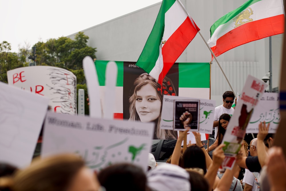 a group of people holding signs and flags