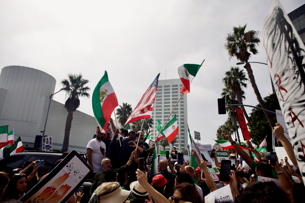 a crowd of people holding flags