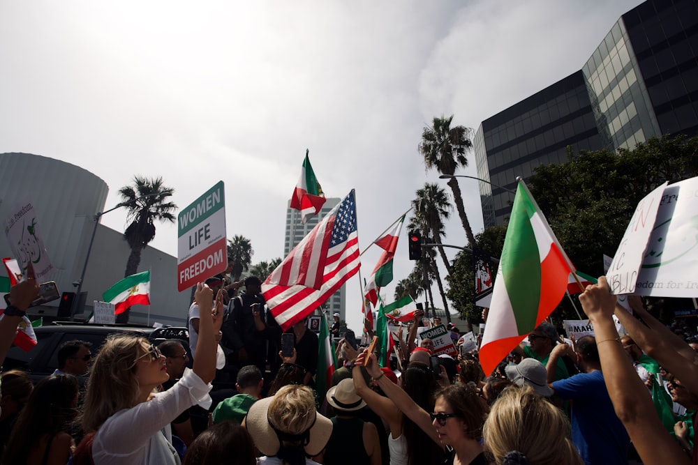 a crowd of people holding flags