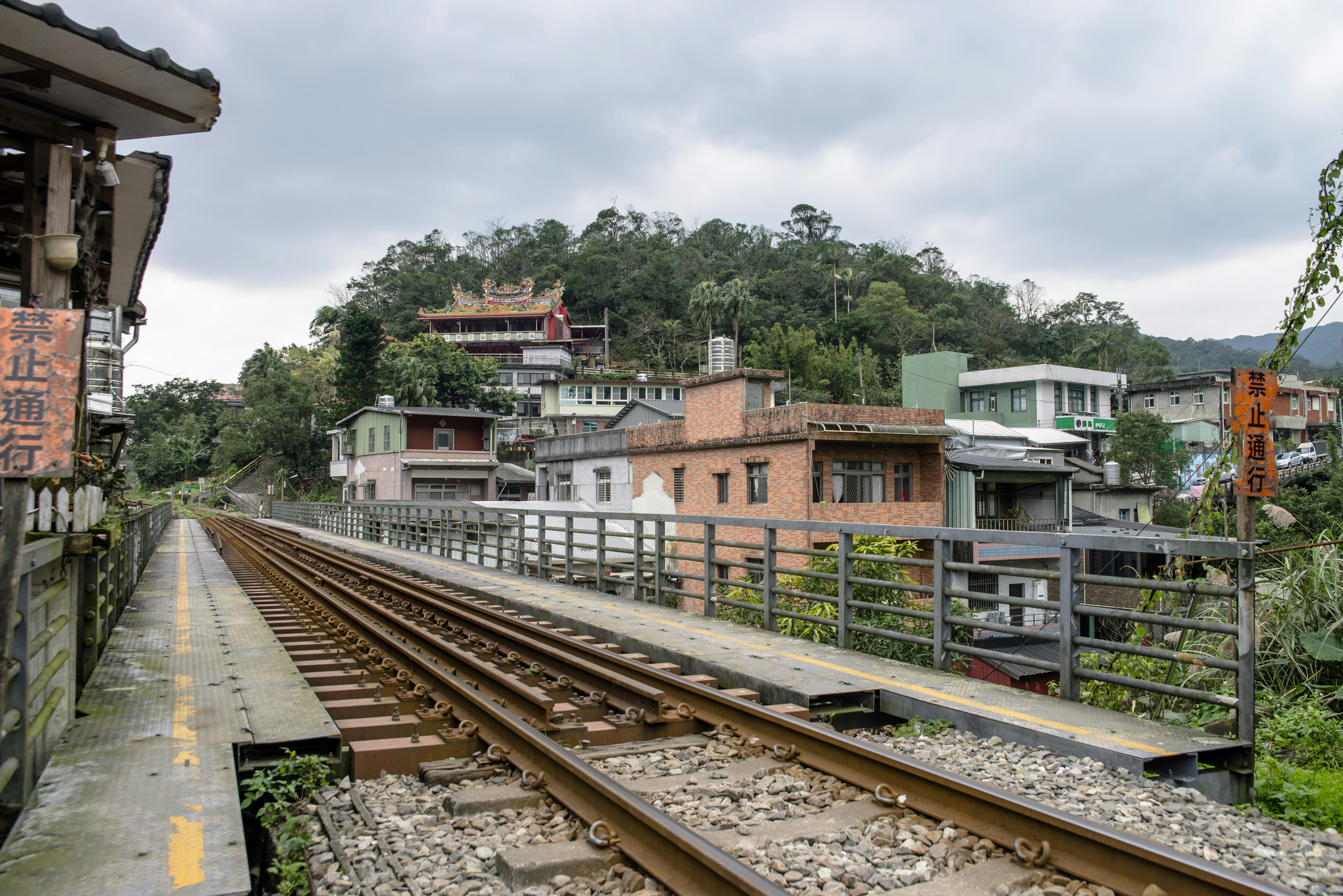 train tracks next to a building