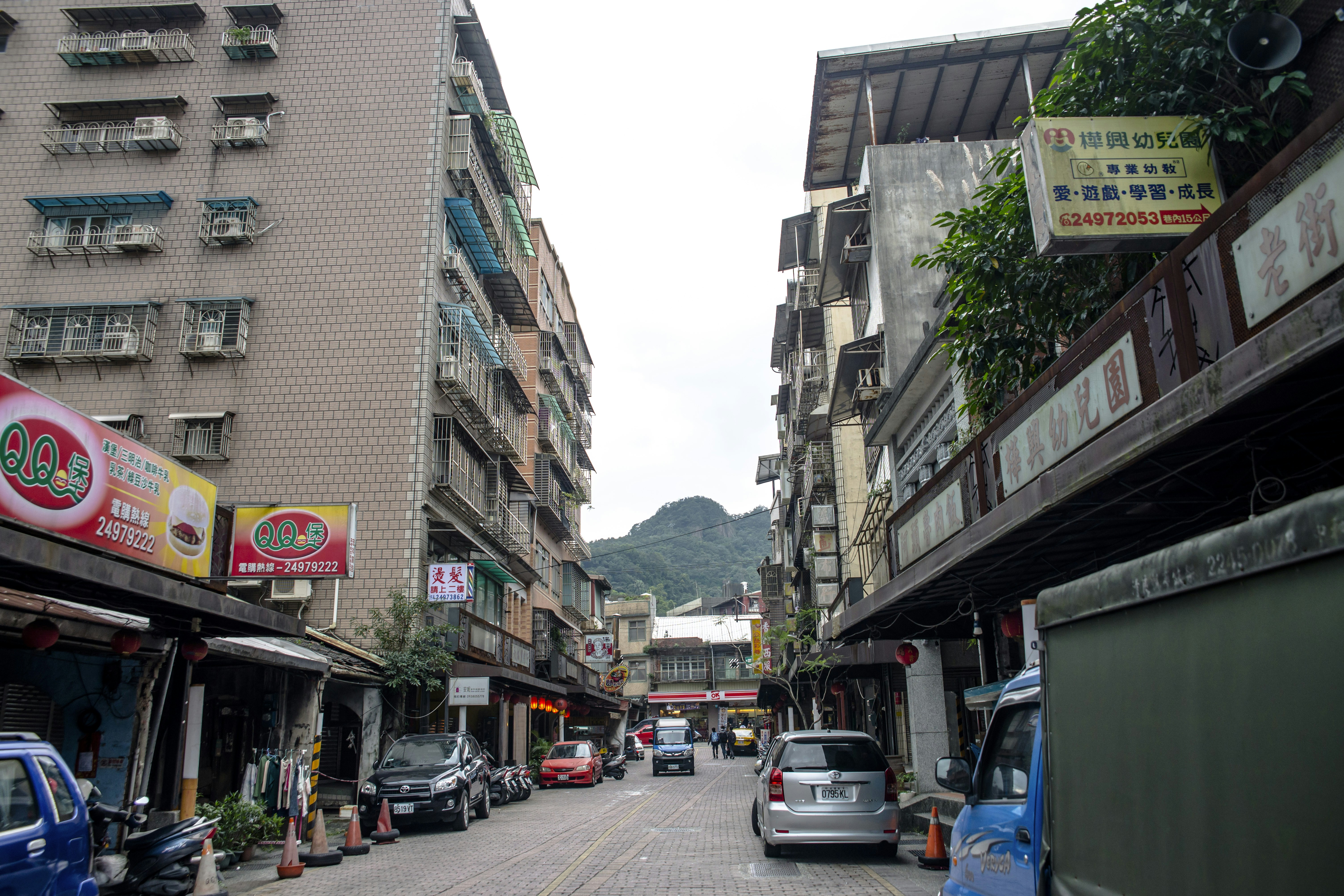 a busy street with cars and buildings