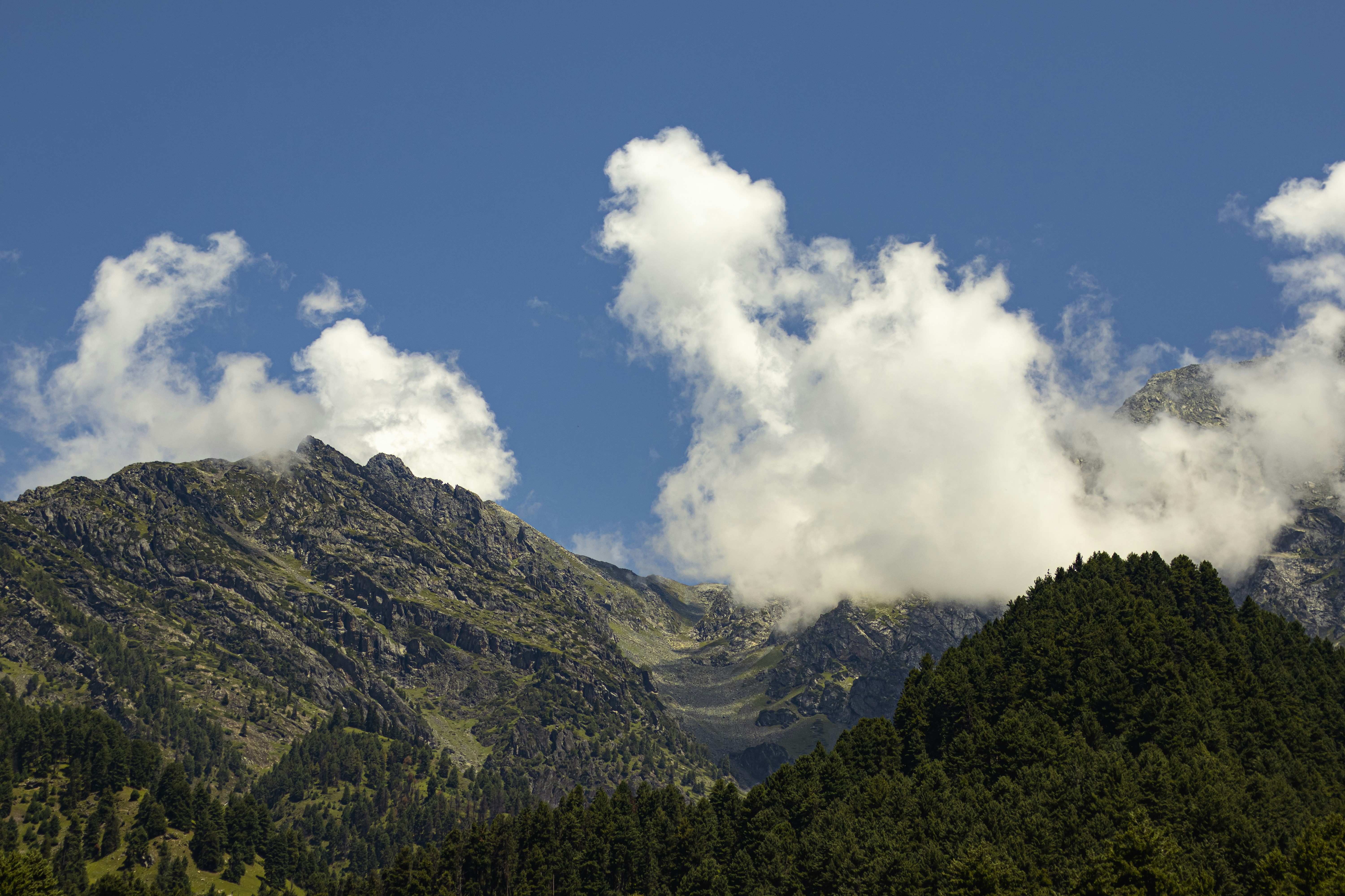 a mountain with clouds, 