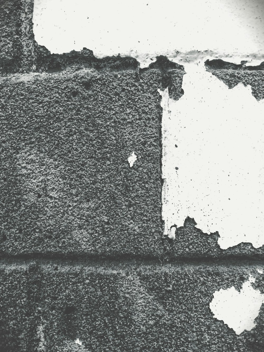a black and white photo of a wall with a hole in it