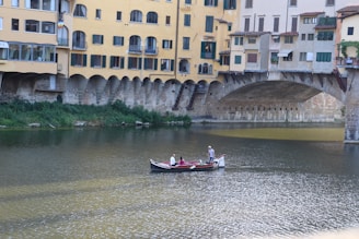 A scenic river cruise passing under ancient stone bridges with a family marveling at the sights from the deck.
