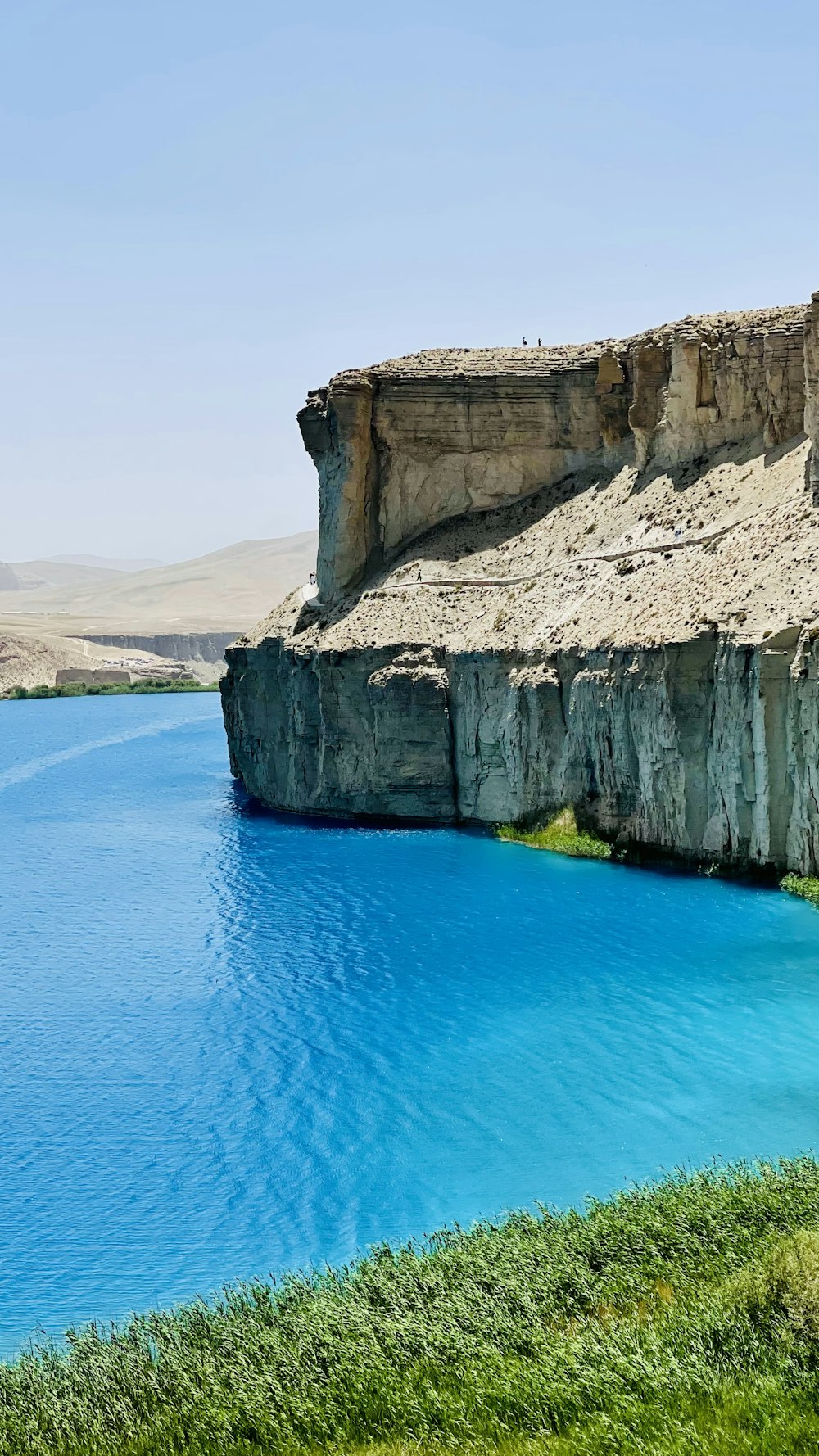 a cliff with a body of water below