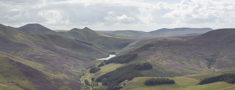 a landscape with hills and a river