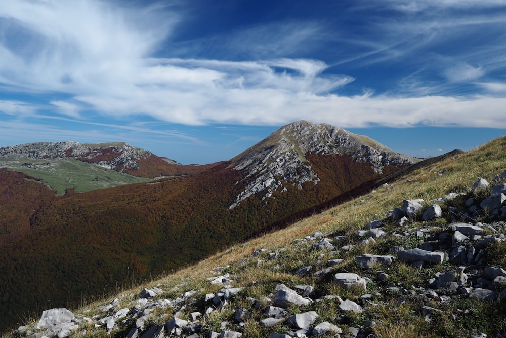 a rocky mountain with a valley below