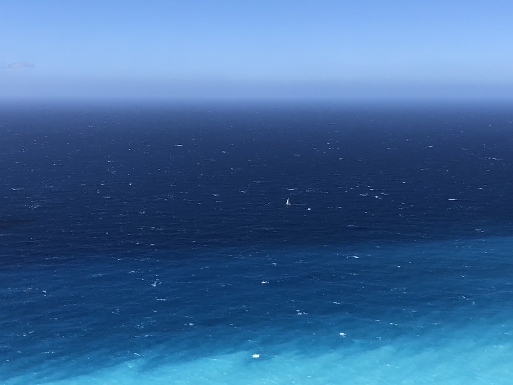 a body of water with a blue sky above it