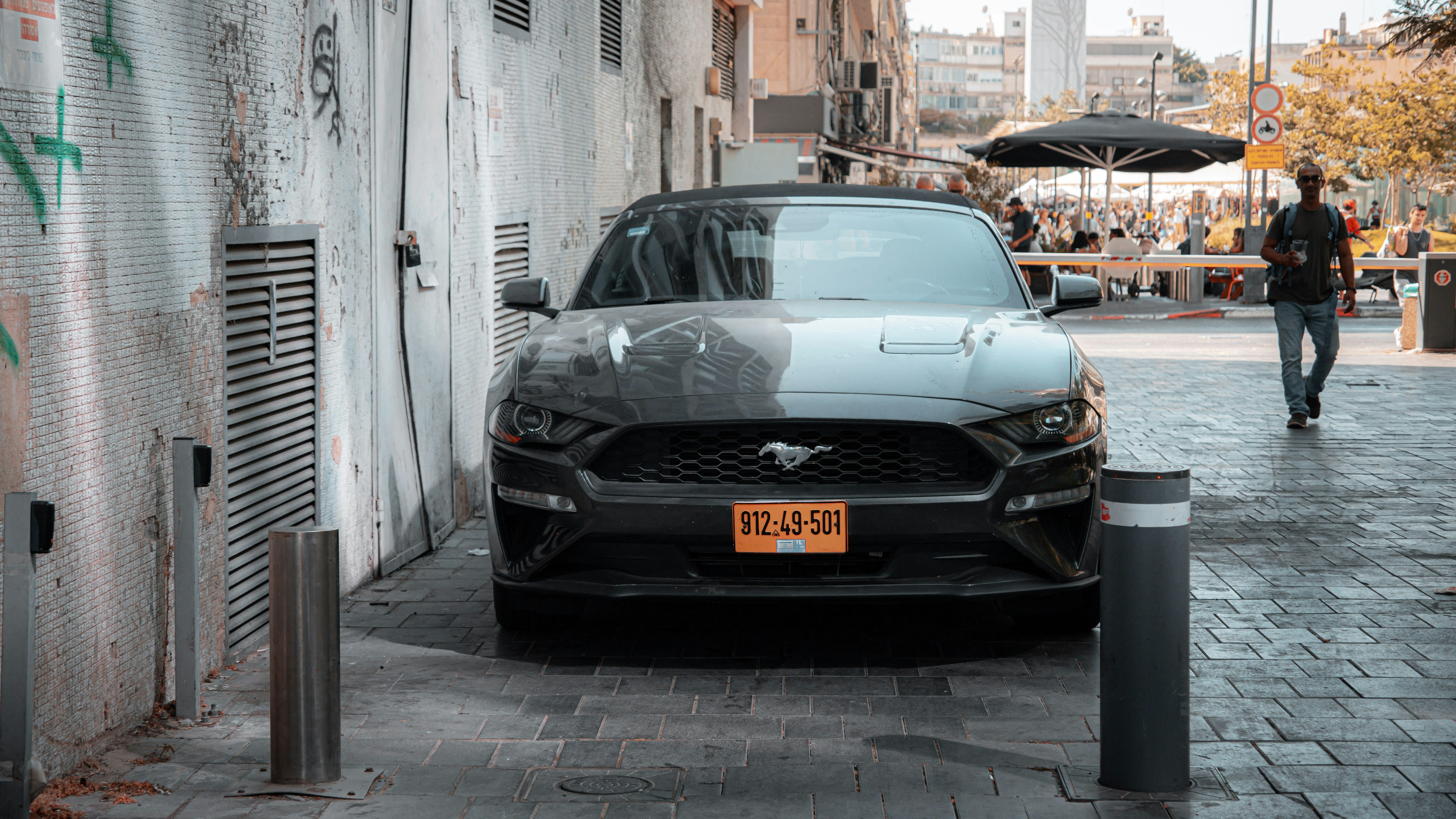 Lineup of different American electric vehicles from several brands parked along a city street