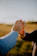 A compassionate caregiver gently holding hands with a smiling resident in a sunlit garden.