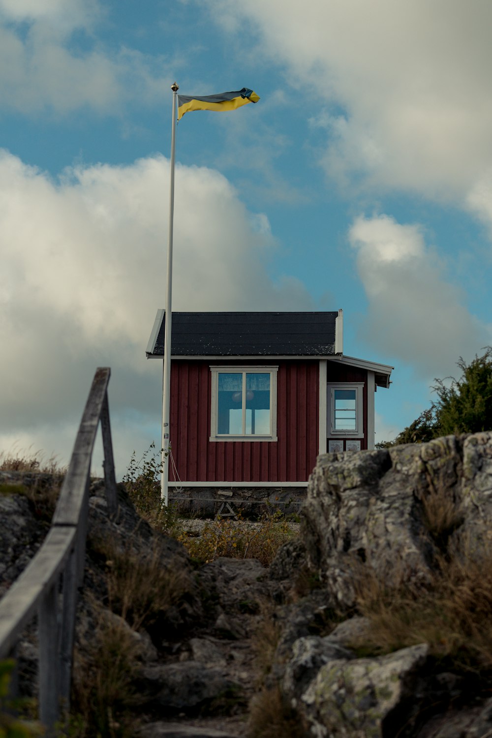 a small red building with a flag on top