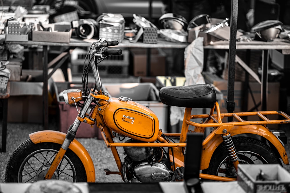 an orange motorcycle in a shop