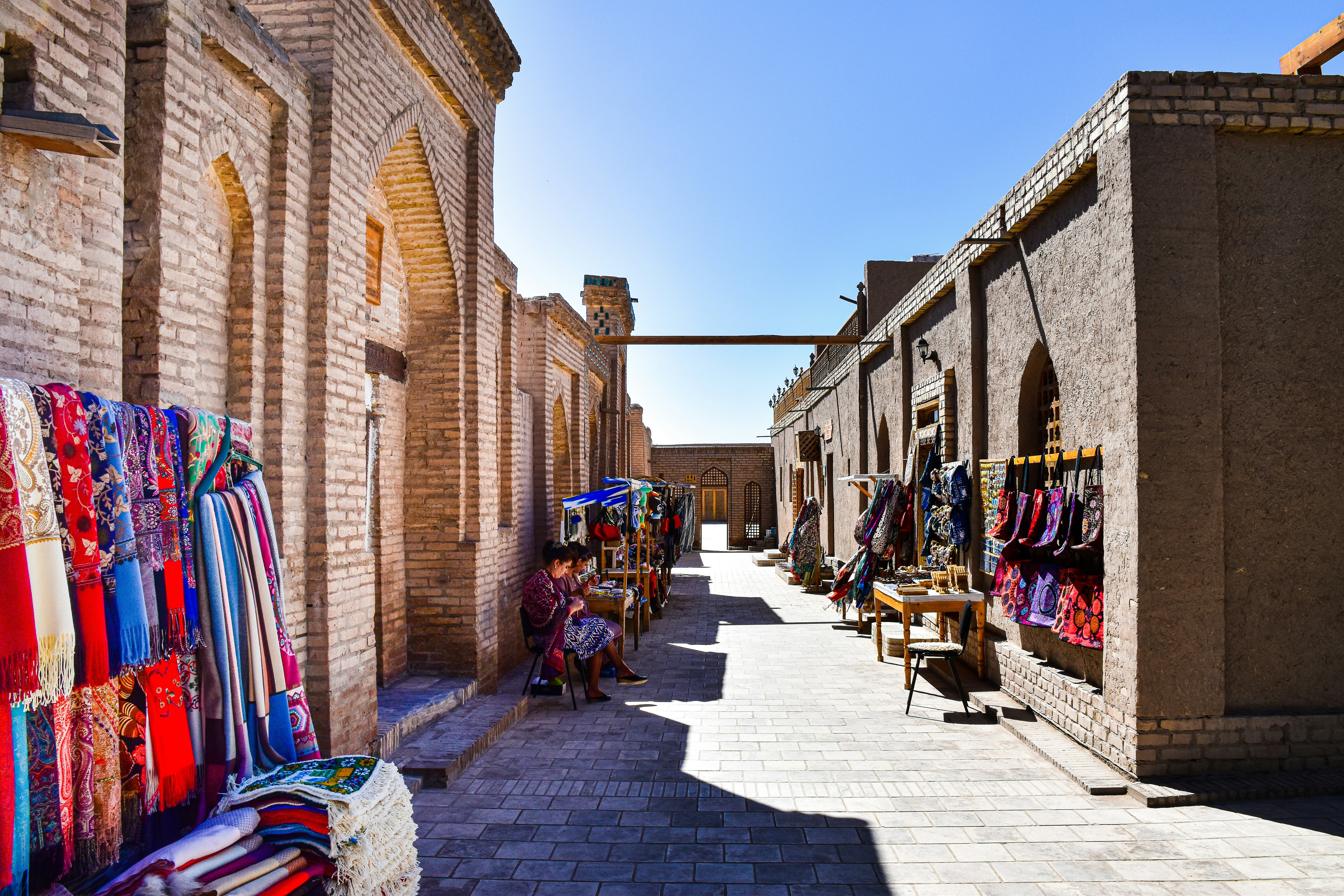 a street with buildings and people, Street life of Khiva, Uzbekistan.