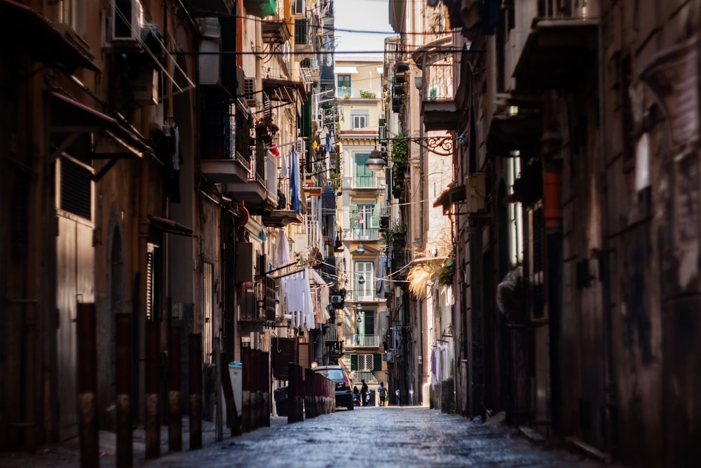 a narrow street with cars