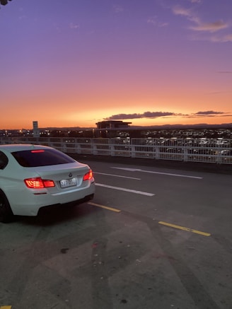 A car parked on a city street at sunset