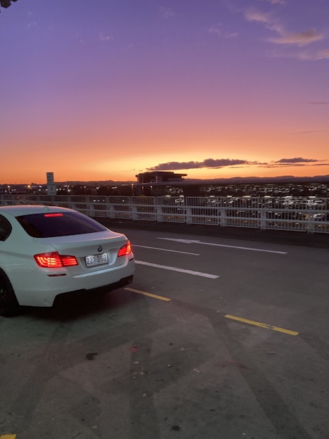 A car parked on a city street at sunset