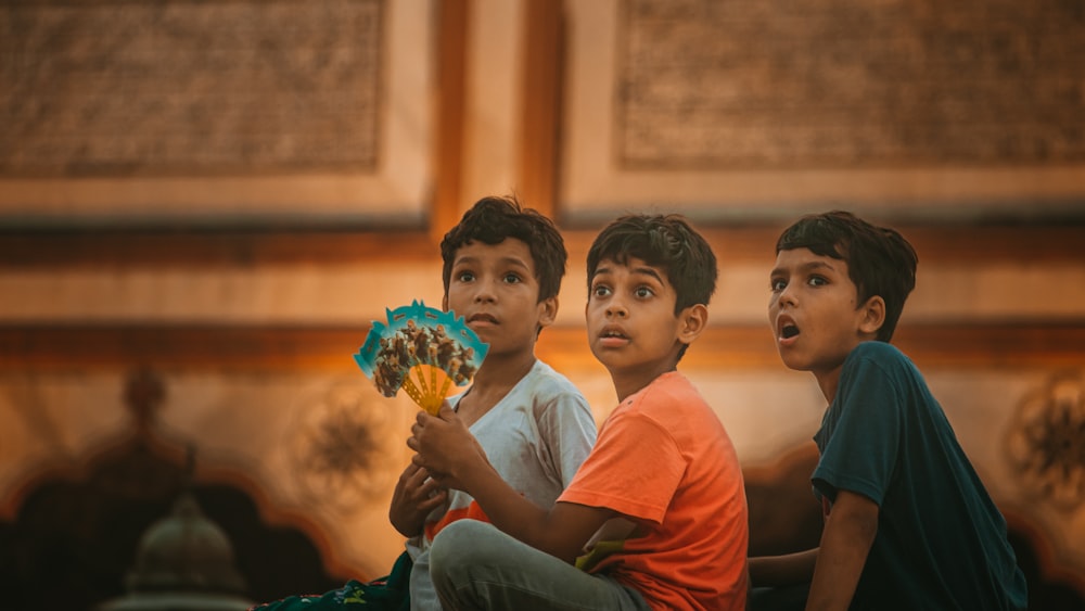 a group of boys sitting in a room