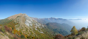 Panoramic view of tranquil mountain landscape with rolling hills and a wide peaceful terrain