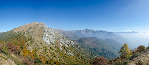 Panoramic view of tranquil mountain landscape with rolling hills and a wide peaceful terrain