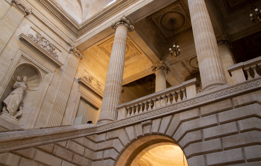 a building with statues and a pillar