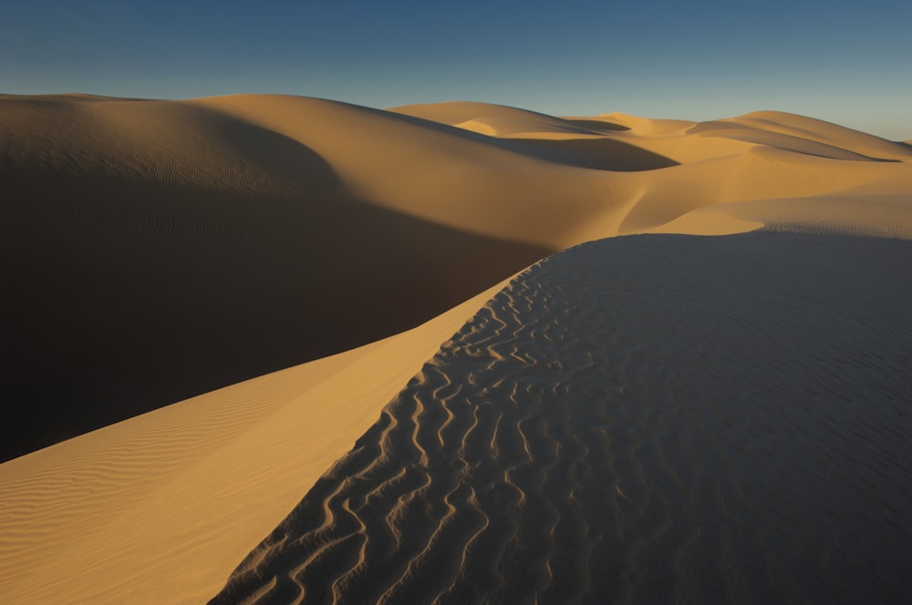 a desert landscape with sand dunes