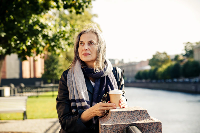 a woman holding a cup of coffee