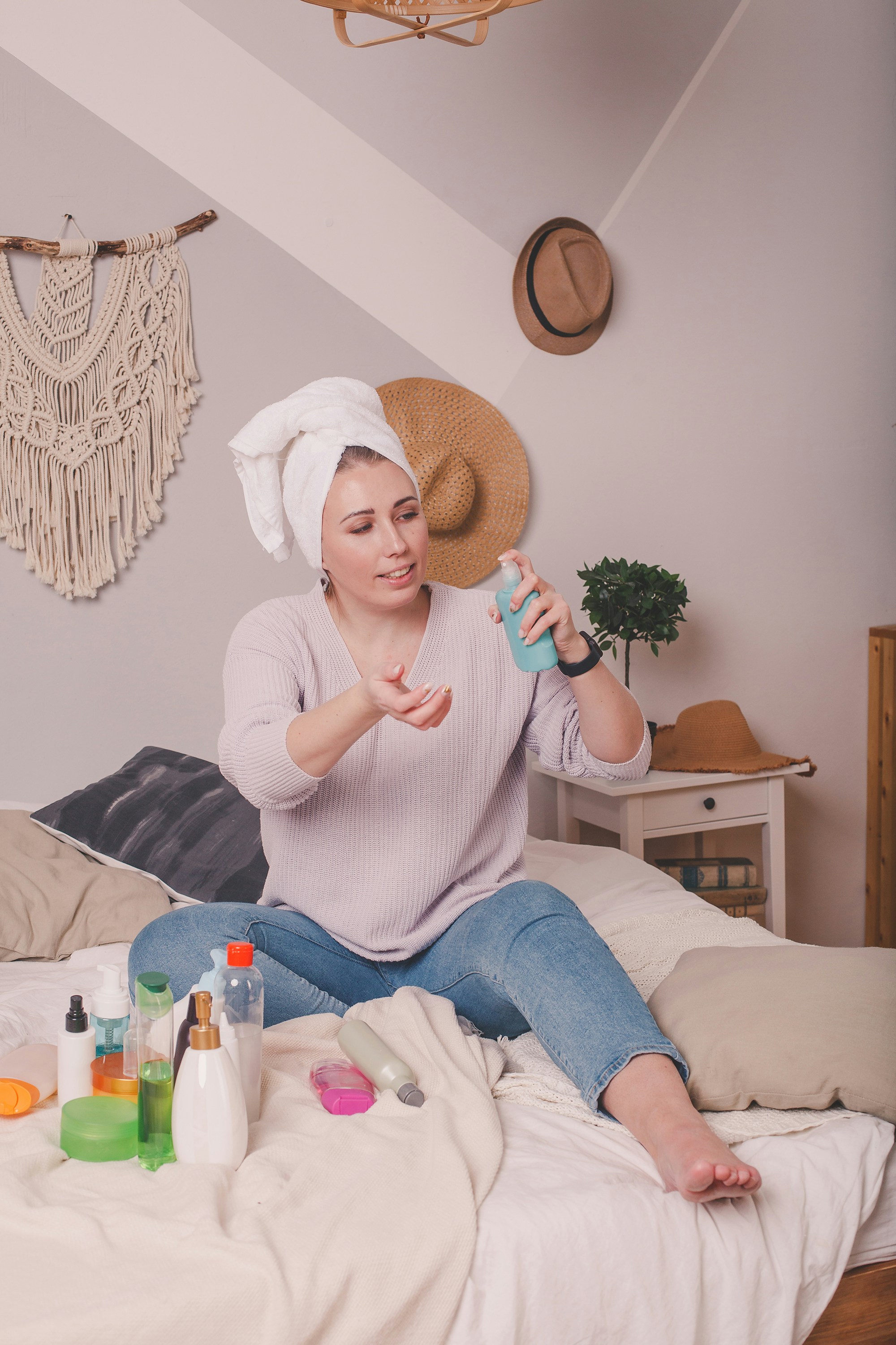 Woman applying moisturizer as part of her winter skincare routine at home