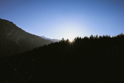 A serene sunrise over a quiet mountain, symbolizing new beginnings and enlightenment.